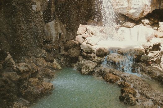 manmade waterfall park. flowing water stream