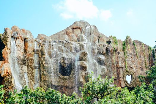 manmade waterfall park. flowing water stream