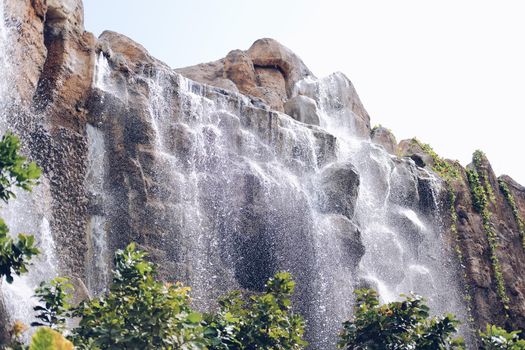 manmade waterfall park. flowing water stream