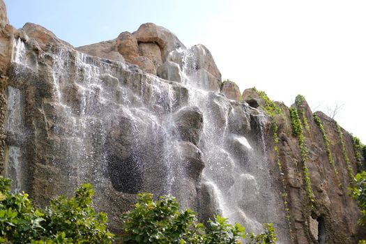 manmade waterfall park. flowing water stream