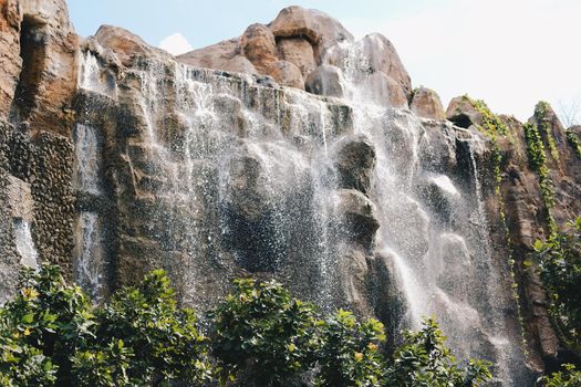 manmade waterfall park. flowing water stream