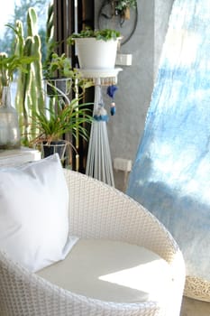 white wicker rattan chair sofa on patio at home