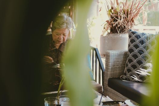old asian elderly senior elder woman eating cheesecake at home