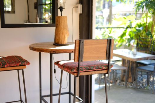 red cushion on wooden chair seat at patio