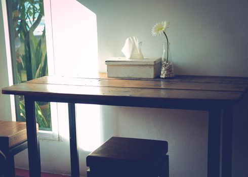 artificial white gerbera flower decorating on wooden table in living room