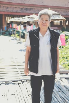 asian old elderly elder woman resting relaxing in garden. senior leisure lifestyle