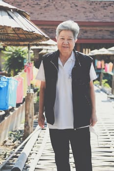 asian old elderly elder woman resting relaxing in garden. senior leisure lifestyle