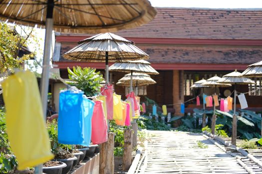 wooden umbrella and fabric lantern decorating along bridge