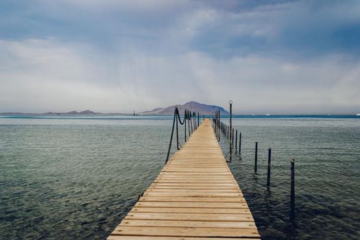 Old wooden pier on the Red sea at overcast day