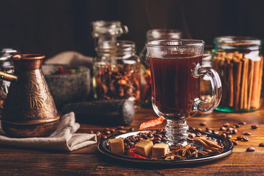 Cezve and Cup of Coffee on Metal Plate with Beans, Refined Sugar and Oriental Spices on Wooden Board.