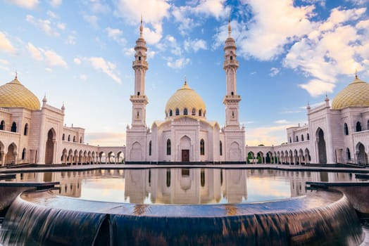 Beautiful White Mosque with Domes and Minarets. Reflection on Water Surface.