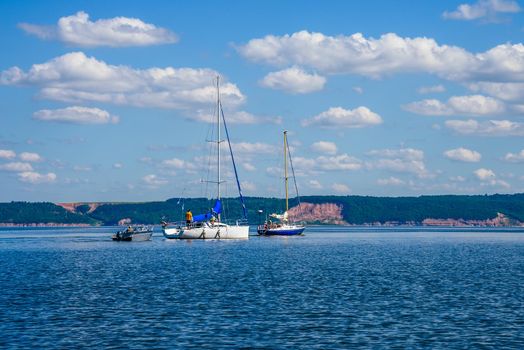 Two Sailing Boats and One Motor Boat on the River.