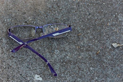 Old broken glasses were left along the footpath.
