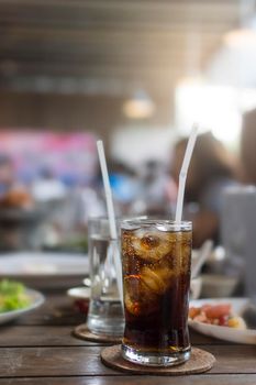 Glass of cola on table at the lunch time