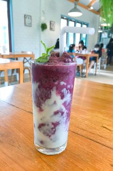 Glass of blueberry smoothie with mint