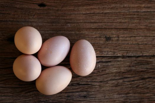 Hen eggs on wood background. Top View.