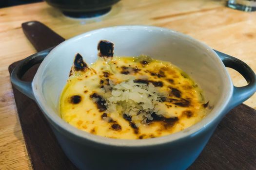 Casserole of polenta on the wooden table