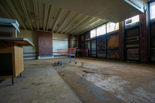 A Shopping Cart Inside a Large Room in an Abandoned Building