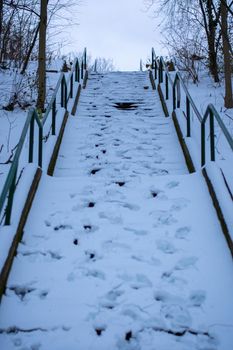 A Large Set of Stairs Covered in Snow With Footsteps In It