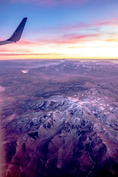 flying over rockies in airplane from salt lake city at sunset