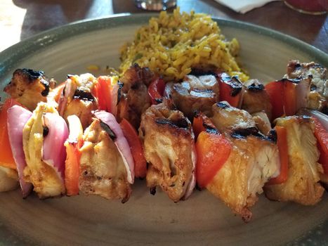 chicken, onion, red peppers, and rice on a plate