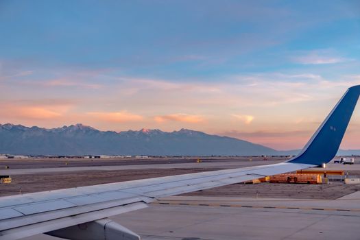 flying over rockies in airplane from salt lake city at sunset