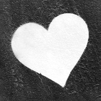 Grunge white heart. Urban love heart hand drawn on grungy wall. Textured background trendy street style. Copy space.