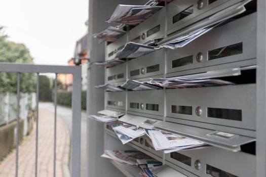 Modern mailboxes filled of flyers. Business and advertising concepts. Shallow depth of field.