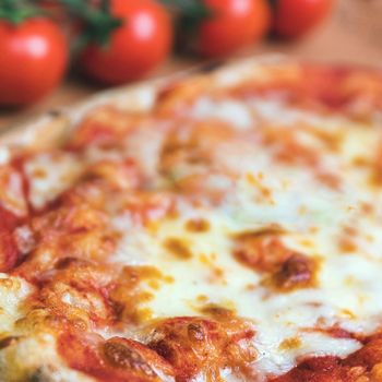 Italian Pizza Margerita. Closeup shot of an italian pizza margherita with tomato souce and mozzarella di bufala cheese. Shallow DOF.