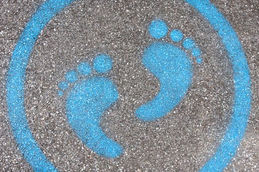 Sign painted on the pavement reminding users to maintain a physical distance of 3 feet / 1 meter during the COVID-19 pandemic.