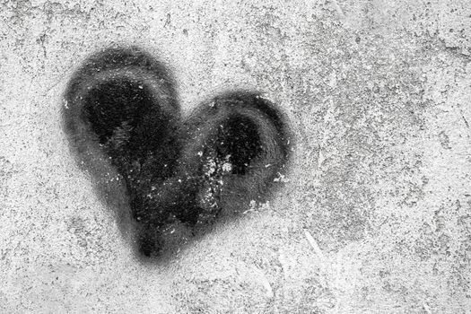 Black heart on grungy wall. Black Heart symbol painted on rustic wall. Ideal for Valentine's Day concept.