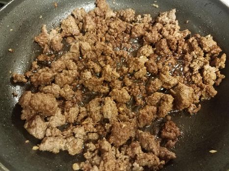 beef and ginger cooking in frying pan or skillet