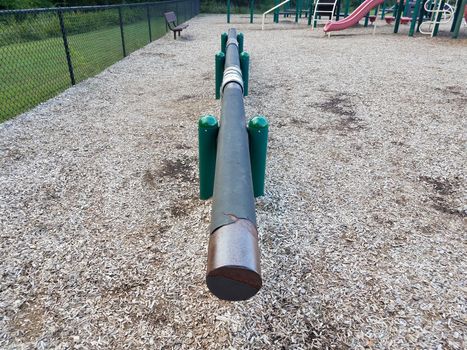 long balance beam at playground or park with brown wood chips