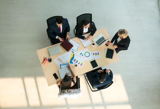 Top view on a group of businessman and businesswoman having a meeting and making a business commitment.