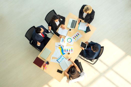 Top view on a group of businessman and businesswoman having a meeting and making a business commitment.