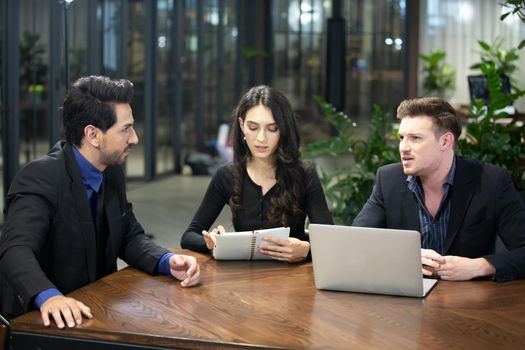 Young business team discussing and studying statistics in a meeting room