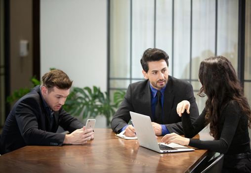 Young business team discussing and studying statistics in a meeting room