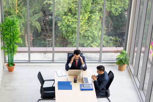 Top view on a group of businessman and businesswoman having a meeting and making a business commitment.