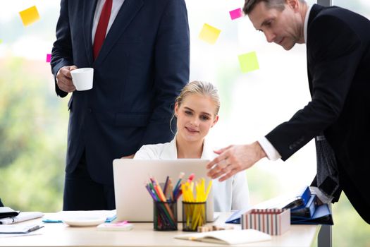 young business team working together at office. Manager pointing at a chart and explaining the analysis about business strategies. Top view shot of business hand shake