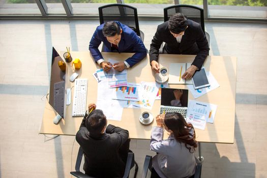 Top view on a group of businessman and businesswoman having a meeting and making a business commitment.