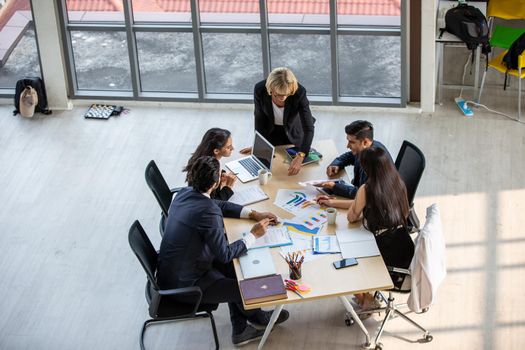 Top view on a group of businessman and businesswoman having a meeting and making a business commitment.