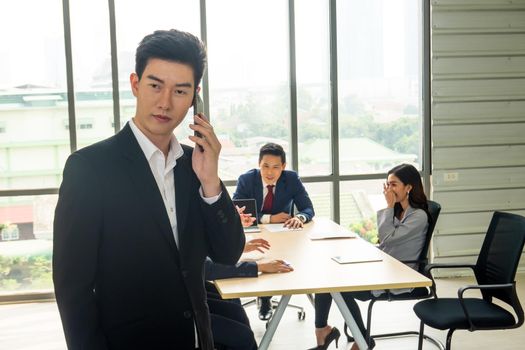 young business team working together at office. Manager pointing at a chart and explaining the analysis about business strategies. Top view shot of business hand shake