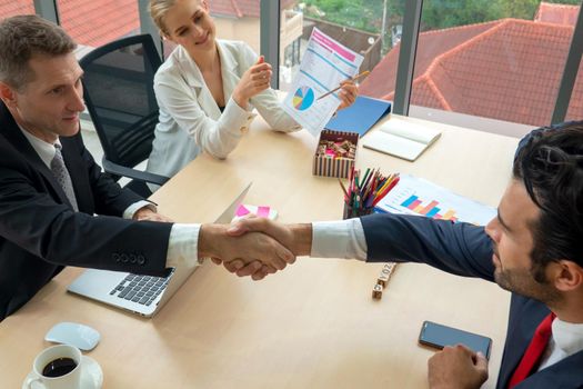 Business people shaking hands in the modern office finishing successful meeting