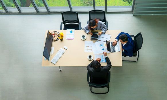 Top view on a group of businessman and businesswoman having a meeting and making a business commitment.