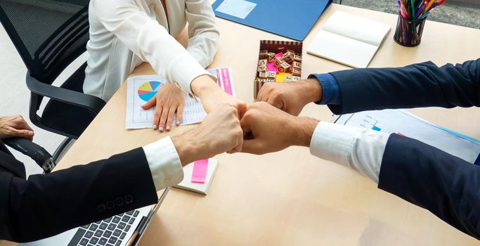 Top view on a group of businessman and businesswoman having a meeting and making a business commitment.