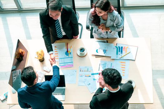 Top view on a group of businessman and businesswoman having a meeting and making a business commitment.