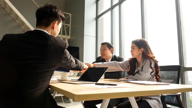 Young business team discussing and studying statistics in a meeting room