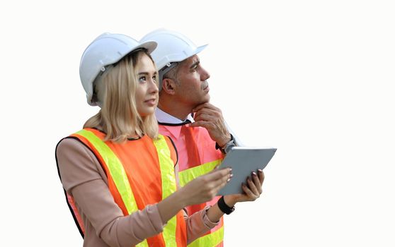 Female industrial engineer wearing a white helmet while standing in a construction site with businessman talking on working plan, Engineer and architects at construction site concept