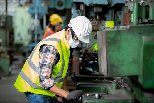 Engineers operating a cnc machine in factory