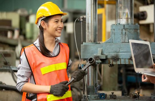 Female Engineers operating a cnc machine in factory